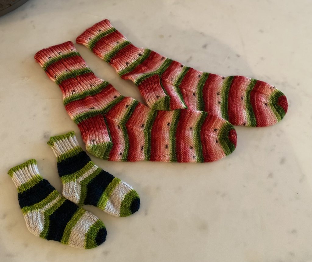 Paires de bas pour maman et bébé, tricotées par la maman d’une directrice d’école.